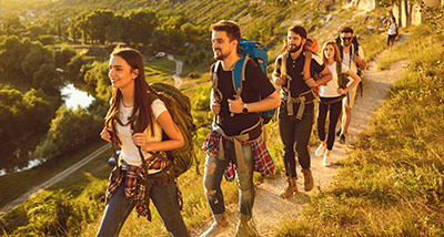 group of friends hiking on a trail in nature enjoying outdoor adventure and scenery four friends engaging in exercise